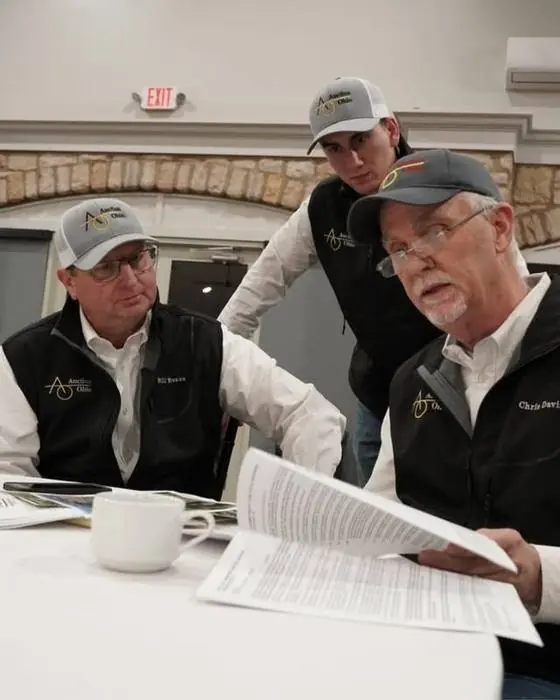 Will Evans reviewing auction documents with the Auction Ohio Real Estate team